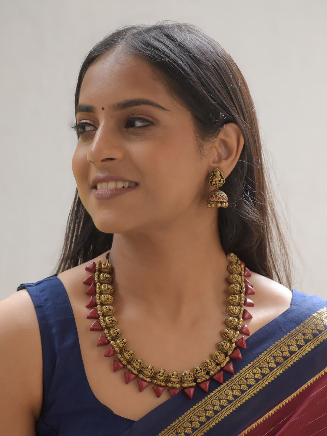 Lalita - Handcrafted Terracotta Lakshmi Motif Necklace Set with Red Cone Beads and Antique Gold Finish Earrings