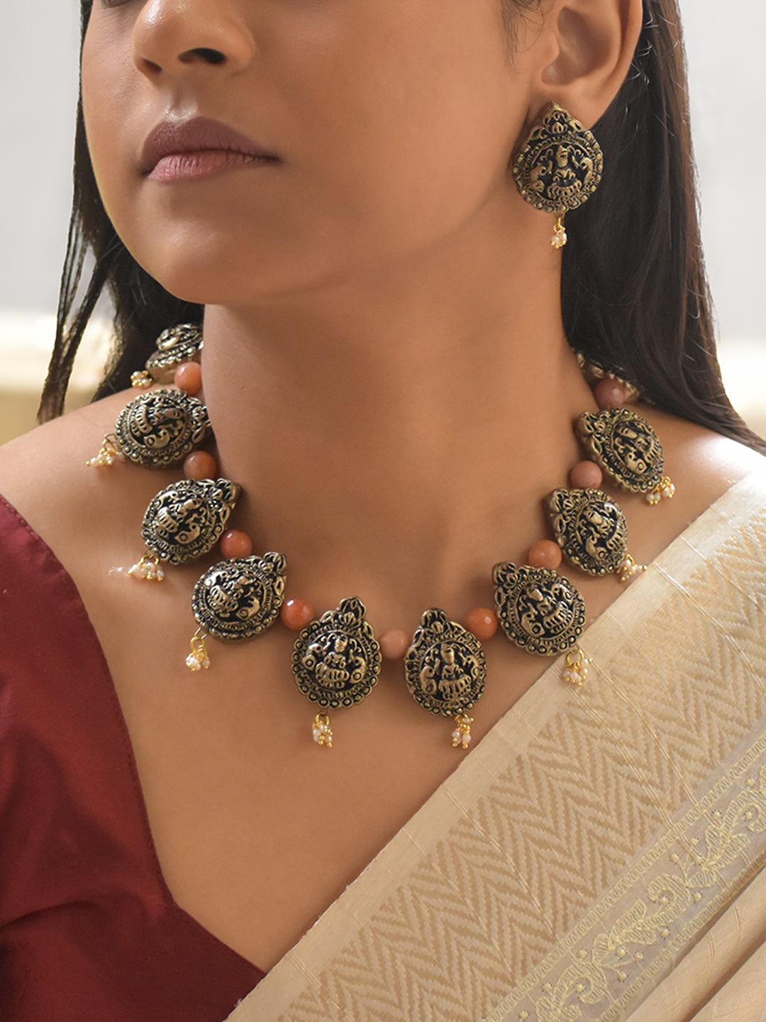 Handcrafted Terracotta Lakshmi Necklace Set with Antique Gold Finish, Orange Beads, and Pearl Danglers