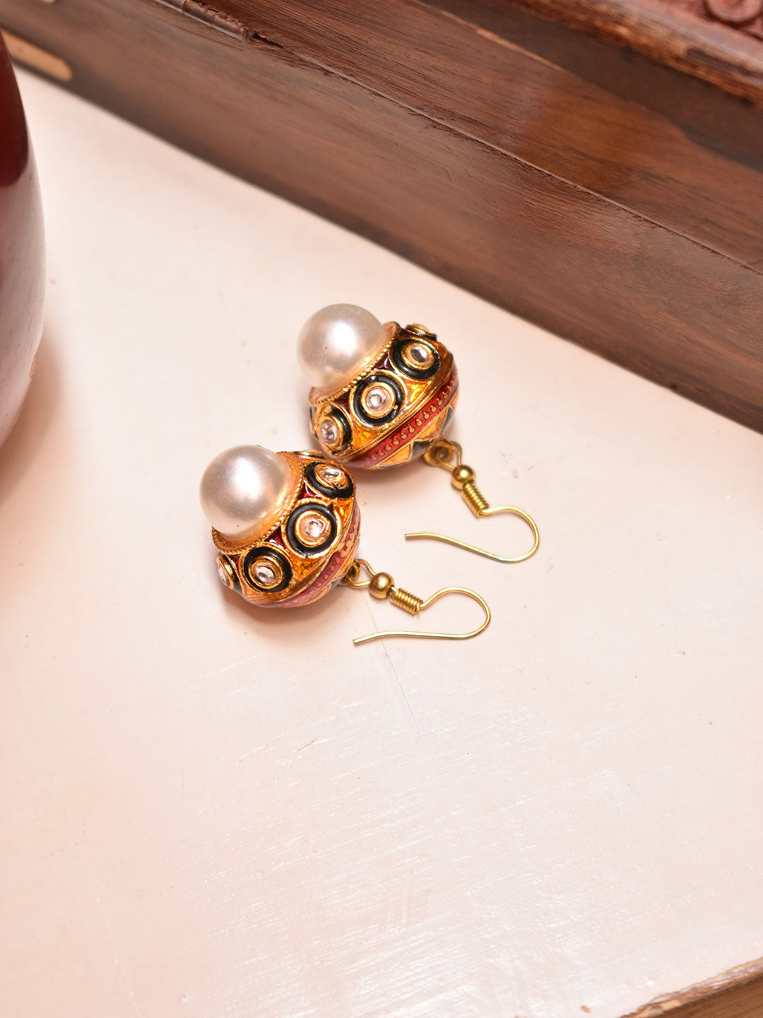 Avismaya Gold Plated Circular Design Gold And Black Color Enamel Painted Dropping Pearl Jhumka Earring