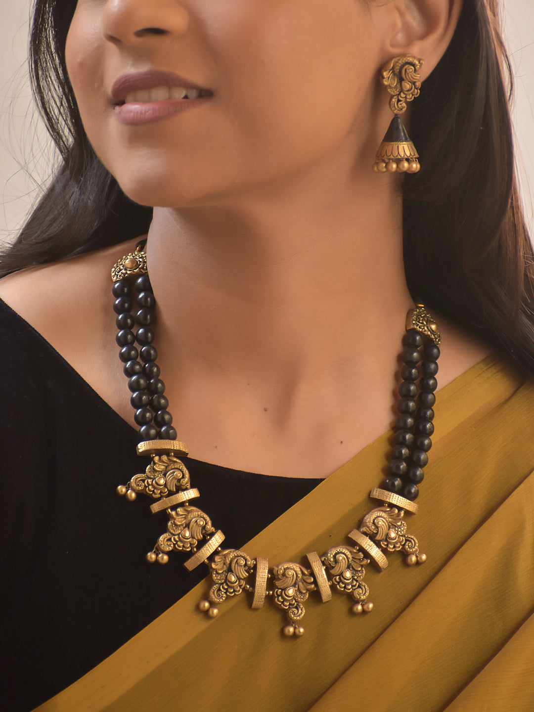 Garudini – Handmade Terracotta Black Bead Necklace Set with Antique Gold Temple Motifs and Matching Jhumkas