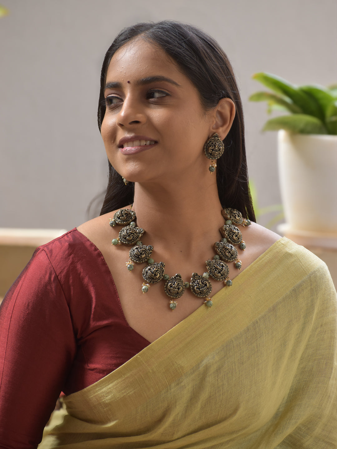 Lakshmi Motifs Terracotta Necklace Set with Green Beads – Antique Gold Finish Stud Earrings