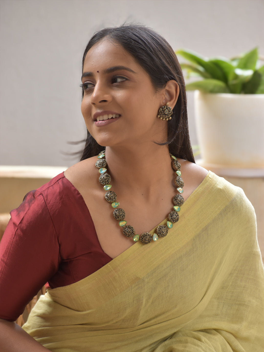 Antique Gold Terracotta Lakshmi Motifs Necklace Set with Green Crystal Drops and Peacock Stud Earrings