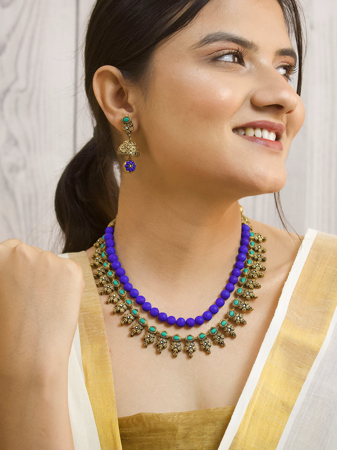 Antique Gold Toned Two Layered Floral Design Motifs With Circular Design Blue Color Beads Terracotta Medium Necklace Set