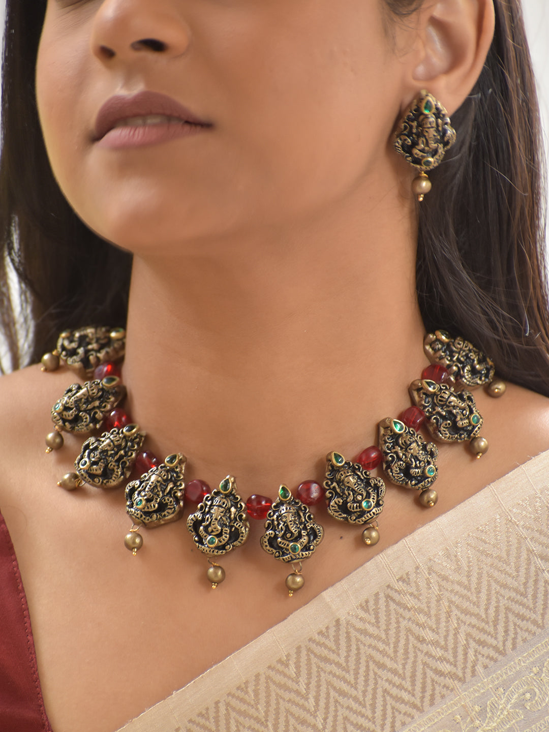 Handcrafted Terracotta Lord Ganesha Necklace Set with Antique Gold Finish, Red Beads, and Green Stone Accents