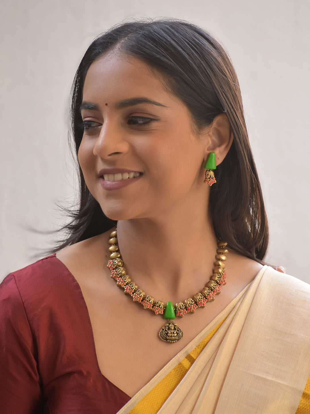 Haram – Terracotta Antique Gold Elephant Motif Necklace with Green Cone Beads & Goddess Pendant