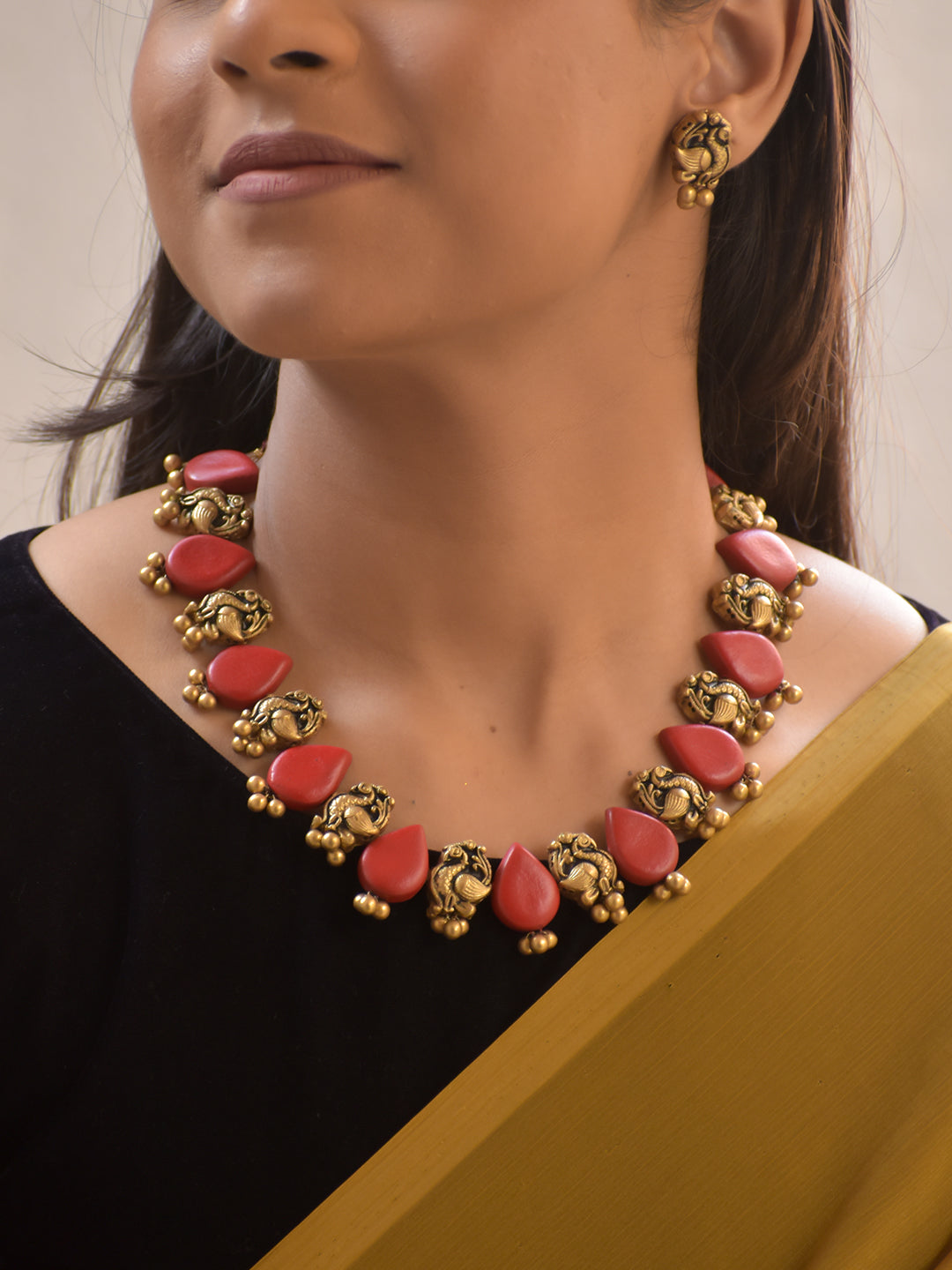 Raktamukhi – Handmade Terracotta Necklace Set with Red Teardrop Beads and Antique Gold Peacock Motifs