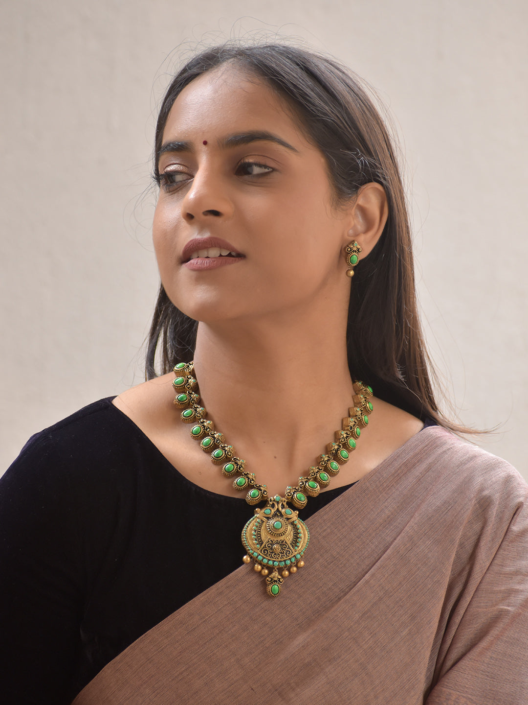 Vaidika – Terracotta Antique Gold and Green Stone Necklace Set with Temple Peacock Motif Pendant and Earrings