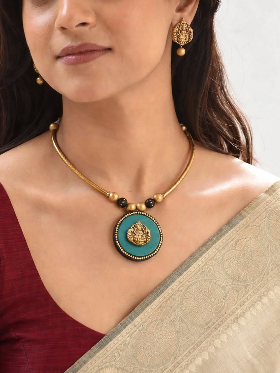 Antique Gold Toned Circular Shape Ganesha Design Pendant Green And Black Color Terracotta Choker Necklace Set