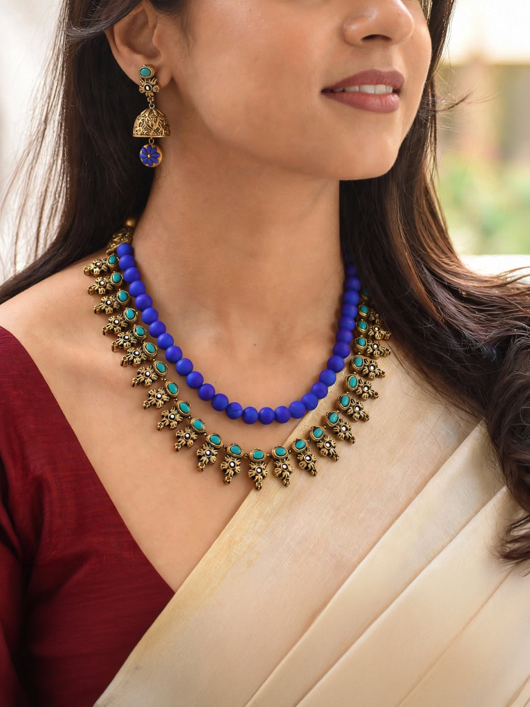 Antique Gold Toned Two Layered Floral Design Motifs With Circular Design Blue Color Beads Terracotta Medium Necklace Set